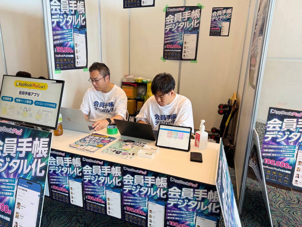 ブースで作業する奥山と小林